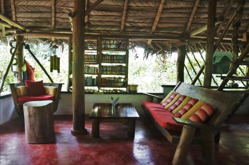 a living room with a couch and a table at El Hotelito Perdido in Rio Dulce