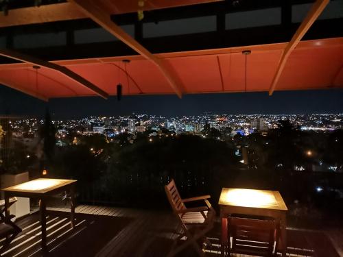 a view of a city at night from a balcony at Casa Alta Hotel Boutique & Spa - Solo Adultos in Villa Carlos Paz