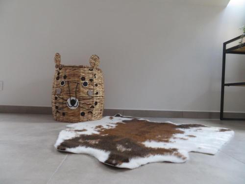 a furry rug on the floor next to a bag at Chez petit Gust Welkom in La Roche en ardenne in La Roche-en-Ardenne