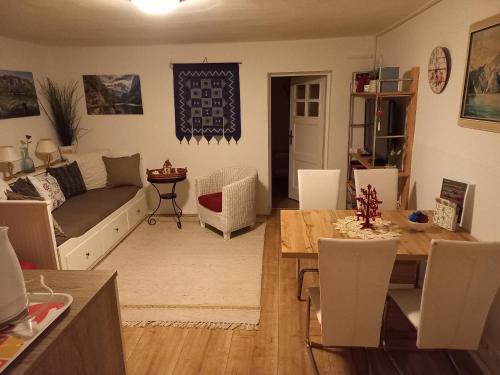a living room with a couch and a table at Apartment Almröserl Edelweiss in Gosau