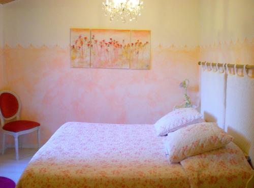 a bedroom with a bed and a chandelier at clos coutin in Gréoux-les-Bains