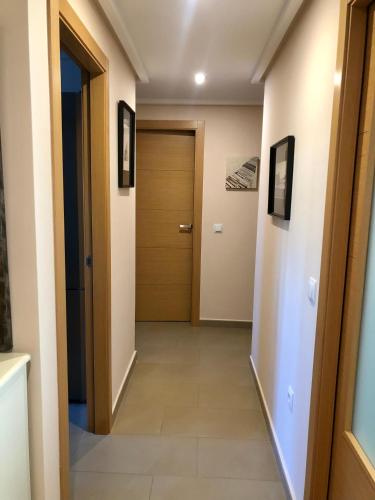 a hallway with a door and a tile floor at Jardines de las Marinas Premium in Denia