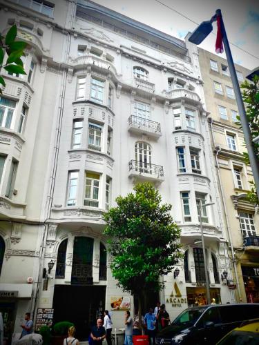 a white building with people standing in front of it at Arcade Hotel & SPA Nisantasi in Istanbul