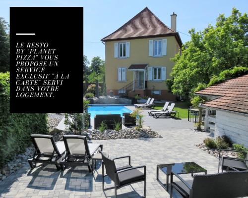 a picture of a patio with chairs and a house at Les Rives des Habsbourg in Ensisheim