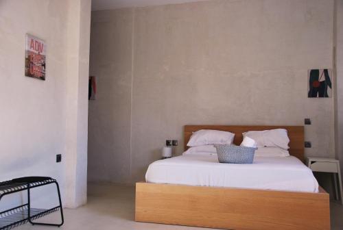 a bedroom with a large bed with white sheets at Staying in Athens in Athens