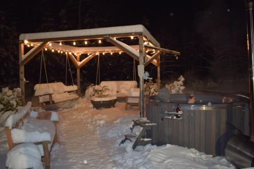 a gazebo covered in snow at night at Pirts "Spārītes" in Geraņimova