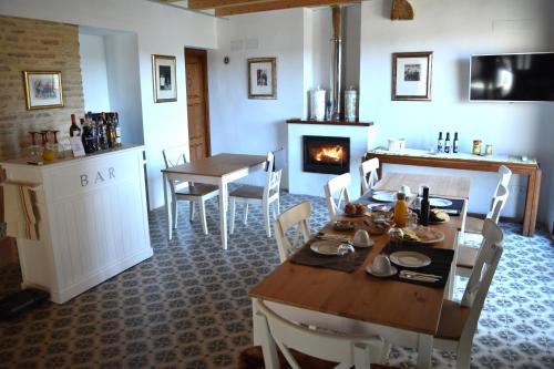 a kitchen and dining room with a table and a fireplace at Castillo-Palacio de Bulbuente in Bulbuente