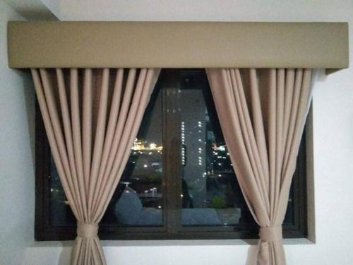 a window with curtains and a view of a city at Persimmon Studios - Studio Unit- 16th Floor - 1641 in Cebu City