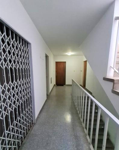 an empty hallway with stairs and a door at Florida Estación in Florida