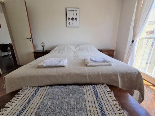 a bedroom with a bed with two towels on it at Florida Estación in Florida