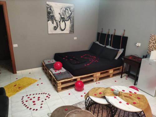 a living room with a bed and two tables at Koa Studio 1 in Korçë