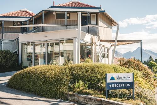 a building with a sign in front of it at Blue Peaks Apartments in Queenstown