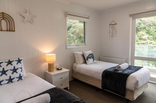 a bedroom with two beds and a window at McMillans of Metung Coastal Resort in Metung