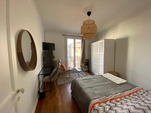 a bedroom with a bed and a mirror and a window at Grande chambre privative à 20 minutes de Paris in Colombes
