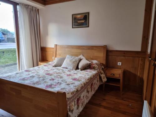 a bedroom with a bed and a window at Pirin Golf Hotel Private Studios in Razlog