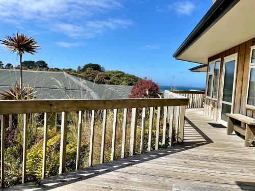 a porch of a house with a bench on it at The Bay Motel in Half-moon Bay