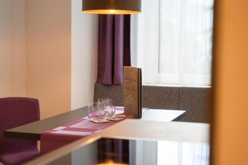 a table with wine glasses and a box on it at Augl‘s Hof in Ischgl