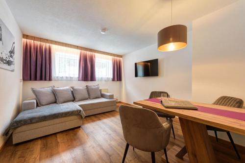 a living room with a couch and a table at Augl‘s Hof in Ischgl