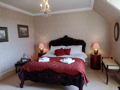 a bedroom with a bed with two towels on it at Bowden House B&B in Melrose