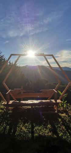 a picnic table with the sun shining behind it at Casa de campo Jaulares in Alaska