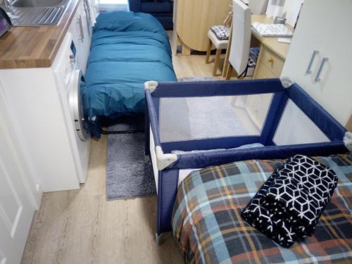a small room with a bunk bed in a kitchen at The Staithe by the Canal. in Lancaster