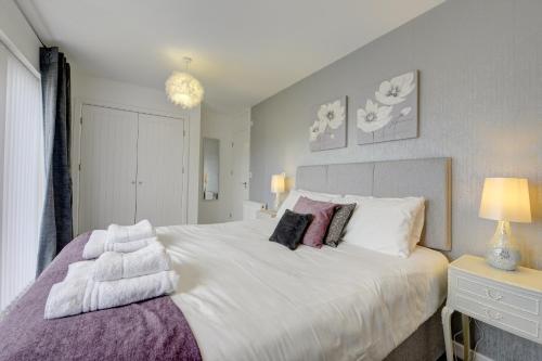 a bedroom with a large white bed with pillows at Marstons Croft in Southam