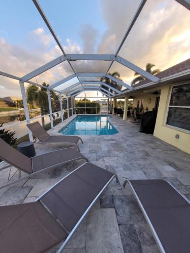 a house with a swimming pool and a patio at Villa Tortuga - Place to Relax in Cape Coral