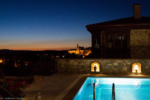 a villa with a swimming pool at night at Ayasoluk Hotel & Restaurant in Selcuk