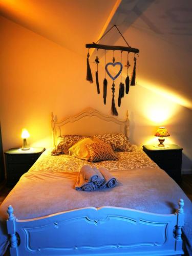 a bedroom with a bed with a heart chandelier at Charming Portuguese style apartment, for rent "Vida à Portuguesa", "Amêndoa or Limão" Alojamento Local in Portimão