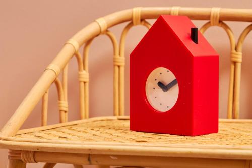 a red bird house sitting on top of a wooden chair at The Exquisite Gem of Newcastle - Sleeps 2 in Newcastle upon Tyne