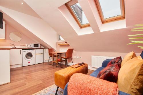 a living room with a couch and a table at The Exquisite Gem of Newcastle - Sleeps 2 in Newcastle upon Tyne