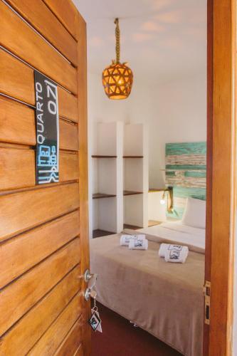 a door leading to a bedroom with a bed at Pousada ON VIBE Cumbuco in Cumbuco