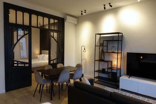 a living room with a table and a bedroom at Casa Clementina - 3 Bedroom Apartment in a Art-Nouveau House in Ghent