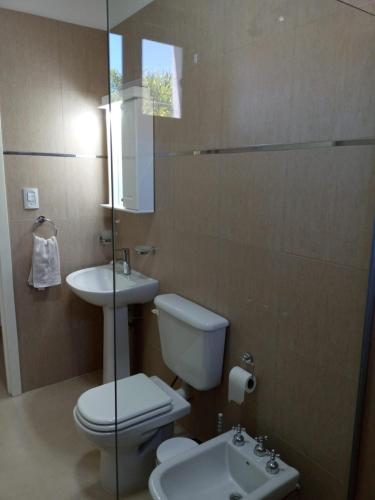 a bathroom with a toilet and a sink at Paseo Camila in Goya