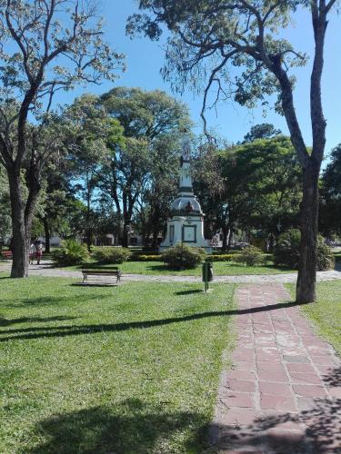 a park with a monument in the distance at Paseo Camila in Goya