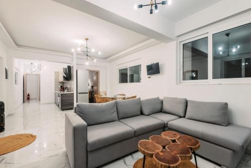 a living room with a couch and a table at Lindos Villa Aqua Euphoria ex Natura in Líndos