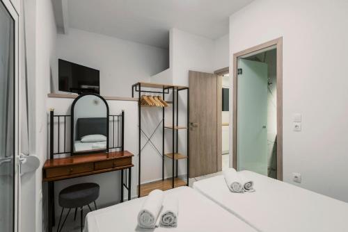 a bedroom with two beds and a mirror at Lindos Villa Aqua Euphoria ex Natura in Líndos