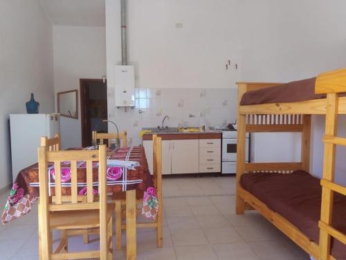a kitchen with two bunk beds and a table and chairs at Rada in Embalse
