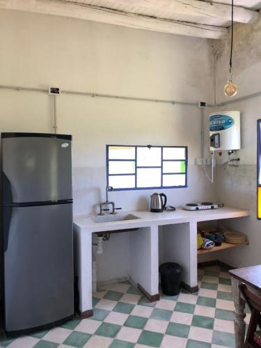 a kitchen with a refrigerator and a sink in a room at El Garzal in Mercedes