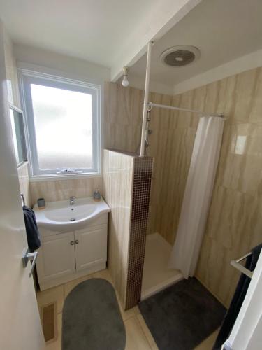 a bathroom with a sink and a shower and a window at Beautiful Holiday Home in Tootgarook/Rye in Tootgarook