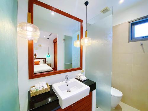 La salle de bains est pourvue d'un lavabo et d'un miroir. dans l'établissement Beautiful 1br Pool Villa Walk To Bangtao Beach, à Ban Thalat Choeng Thale