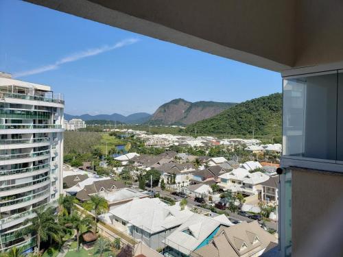a view of a city from the balcony of a building at Condomínio Encantador (Blue das Americas) in Rio de Janeiro