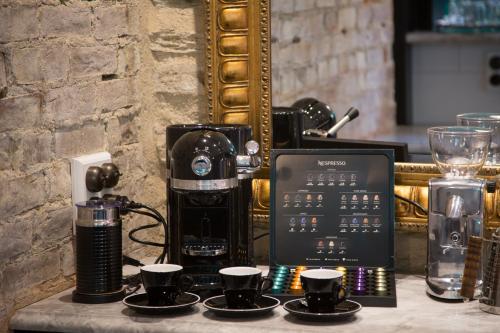 a coffee machine sitting on a table with cups at Hulbert House Luxury Boutique Lodge Queenstown in Queenstown