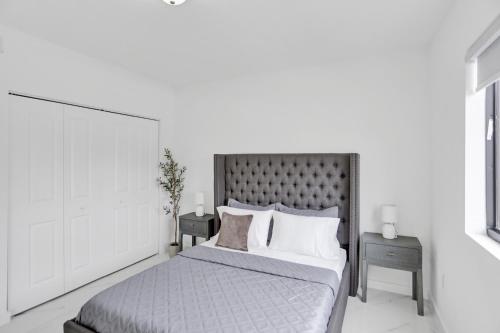 a bedroom with a large bed with two night stands at Renzzi Wynwood Apartments in Miami
