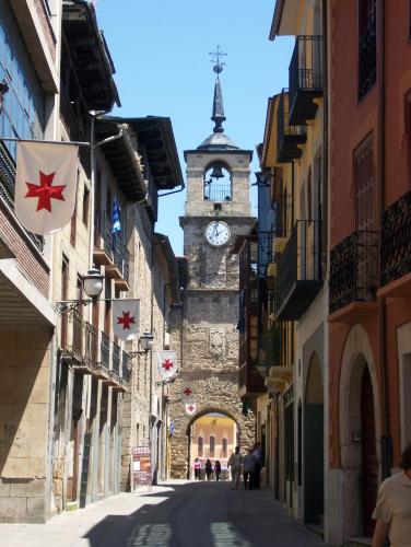 a building with a clock tower in a street at Hostal Monteclaro in Ponferrada
