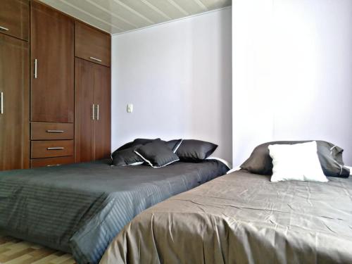 Ένα ή περισσότερα κρεβάτια σε δωμάτιο στο Living Robayo Paipa