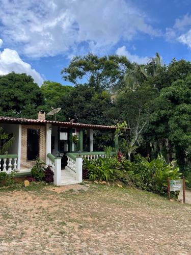 a small house in the middle of a yard at Olho D'Água Pousada in Guaramiranga