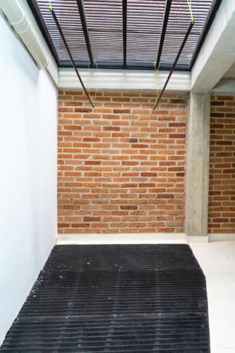 a room with a brick wall and a black mat at M1145 Aparta Loft in Pereira