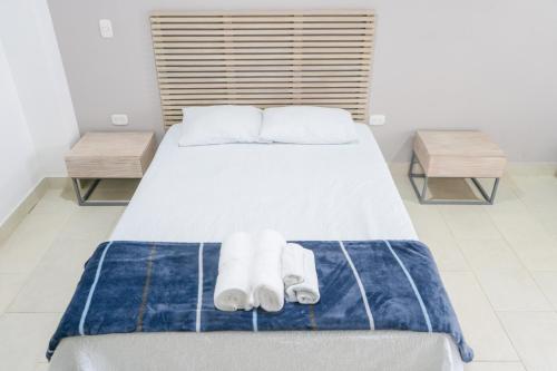 a bedroom with a bed with towels on it at M1145 Aparta Loft in Pereira