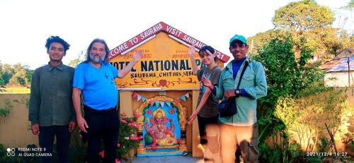 a group of people standing in front of a sign at Hotel National Park Sauraha- Homely Stay and Peaceful Location with Jungle Safari arrangements in Sauraha